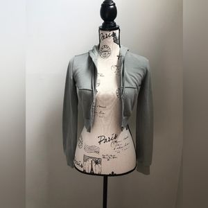 Cropped green zip up from H&M with 2 little each stains on the arm